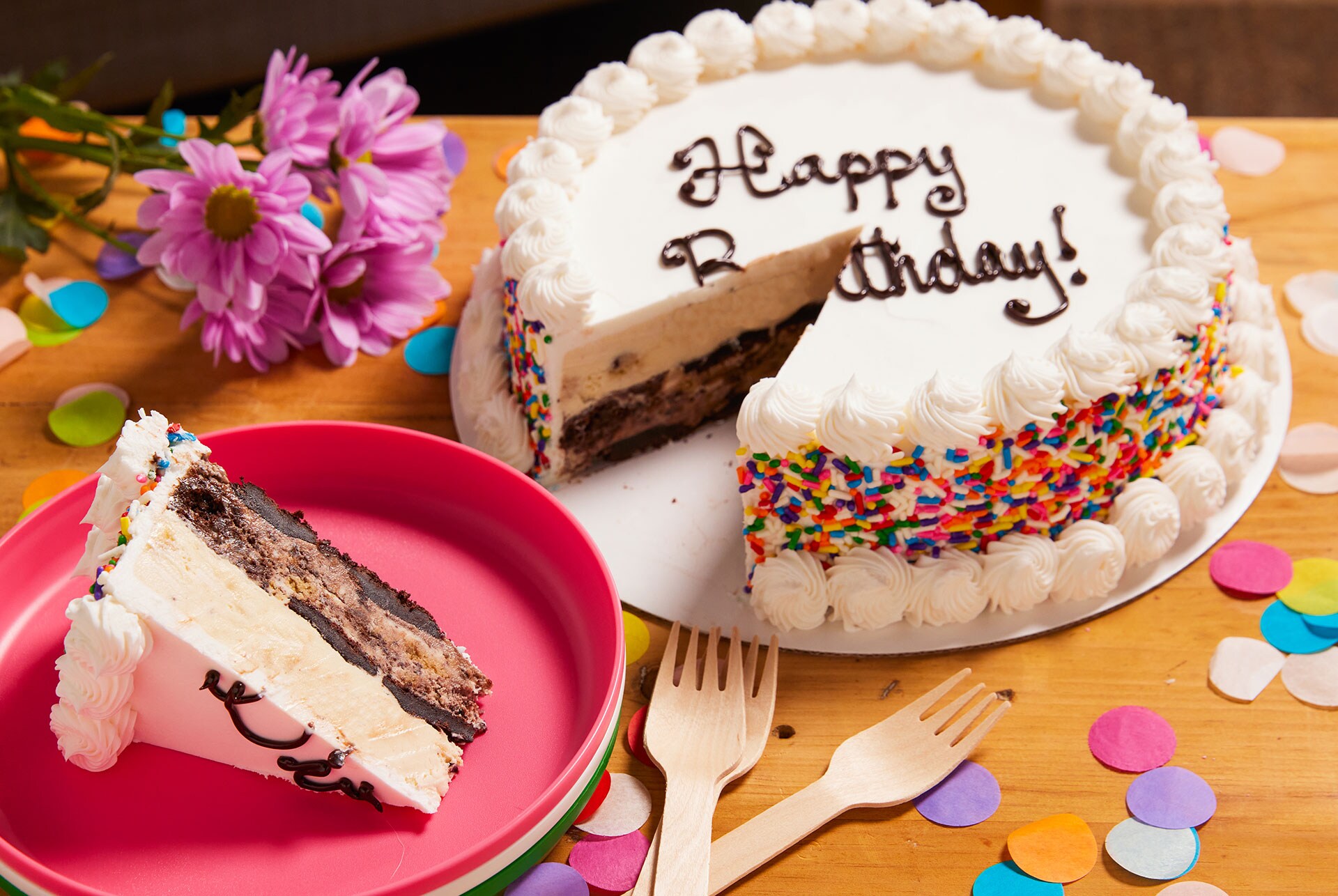 An ice cream cake with a slice from it on a plate